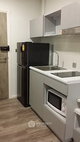 Modern compact kitchen with sleek appliances and stylish cabinetry