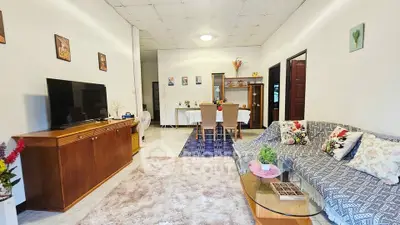 Spacious living room with cozy decor and modern furniture, perfect for family gatherings.