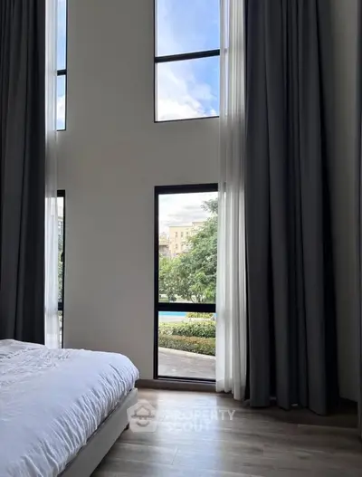 Luxurious bedroom with floor-to-ceiling windows and elegant curtains