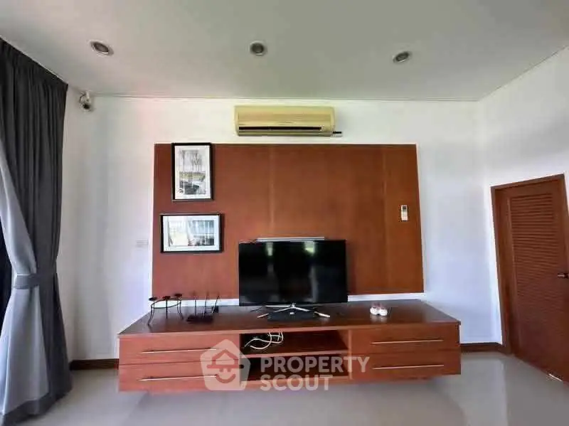 Modern living room with sleek TV unit and air conditioning