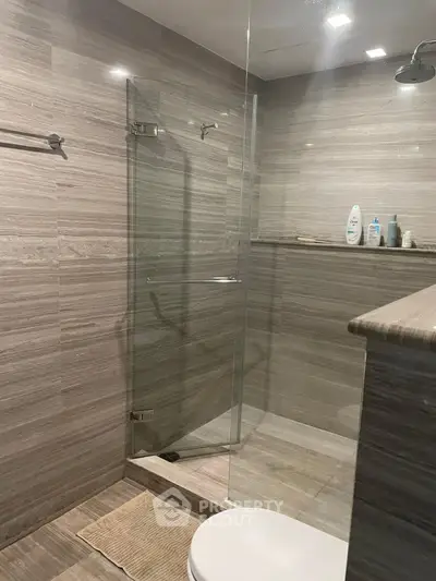 Modern bathroom with glass shower and sleek tile design