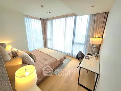 Luxurious bedroom with floor-to-ceiling windows and elegant decor in modern apartment.