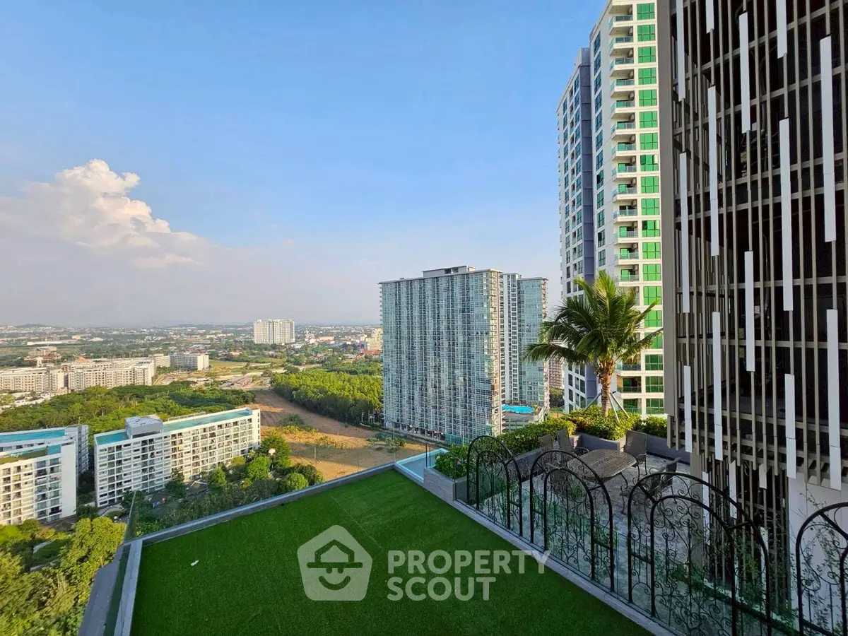 Stunning high-rise building view with lush green surroundings and clear blue sky.