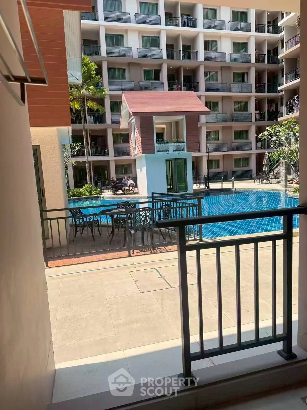 Luxurious apartment complex with inviting pool and spacious balconies, perfect for relaxation and leisure.