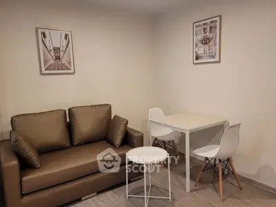 Cozy living room with modern sofa and dining area, perfect for small apartments.