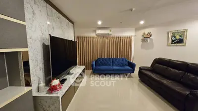Spacious living room with modern decor and comfortable seating