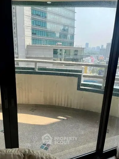 Spacious balcony with city view in modern high-rise apartment