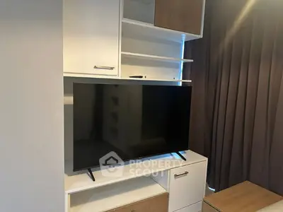 Modern living room with sleek TV unit and stylish storage cabinets.