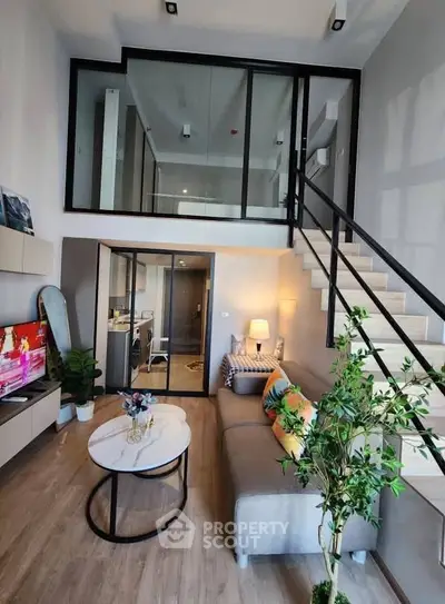 Modern loft-style living room with mezzanine, stylish decor, and open layout for urban living.