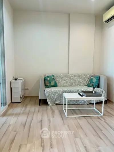 Modern living room with sleek wooden flooring and minimalist furniture design.