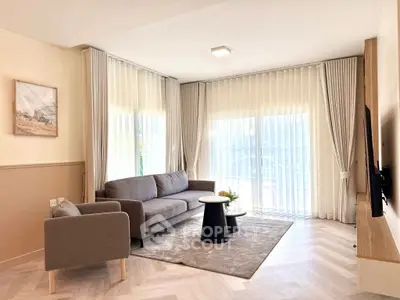 Modern living room with stylish furniture and large windows