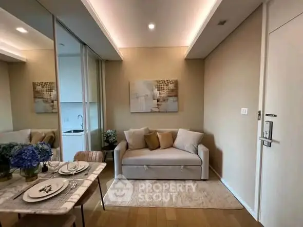 Modern living room with cozy sofa and elegant dining setup in a stylish apartment.