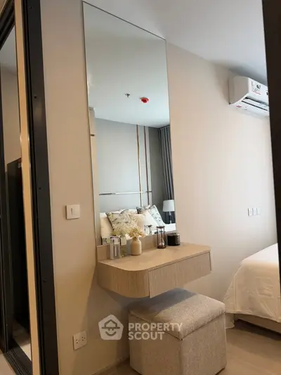 Modern bedroom with stylish vanity and comfortable bed in a cozy apartment.