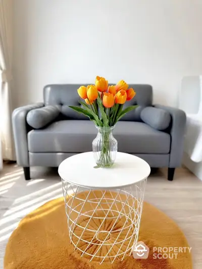 Modern living room with stylish gray sofa and vibrant tulip centerpiece