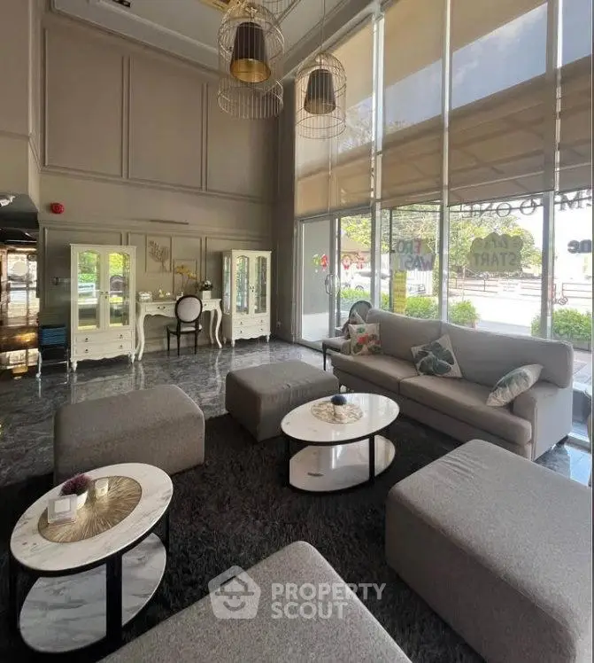 Luxurious modern living room with elegant furniture and large windows offering natural light.