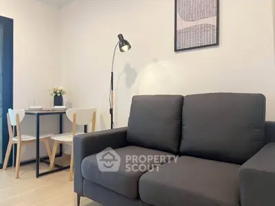 Modern living room with sleek sofa and dining area in stylish apartment