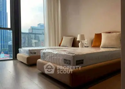 Modern bedroom with twin beds and city view in luxury apartment