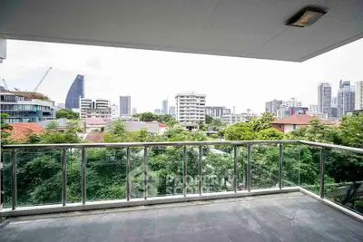 Spacious balcony with stunning city skyline view, perfect for relaxation and entertaining.