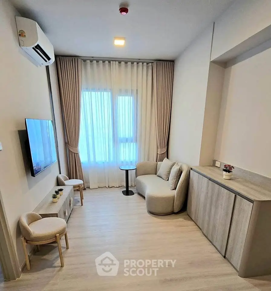 Modern living room with stylish furniture and natural light, perfect for cozy relaxation.