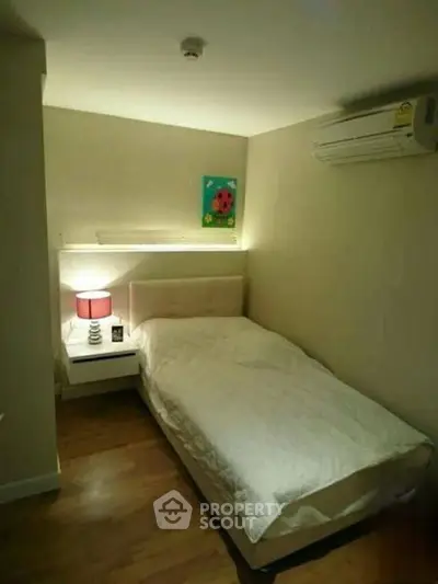 Cozy bedroom with modern decor and air conditioning, perfect for a comfortable living experience.