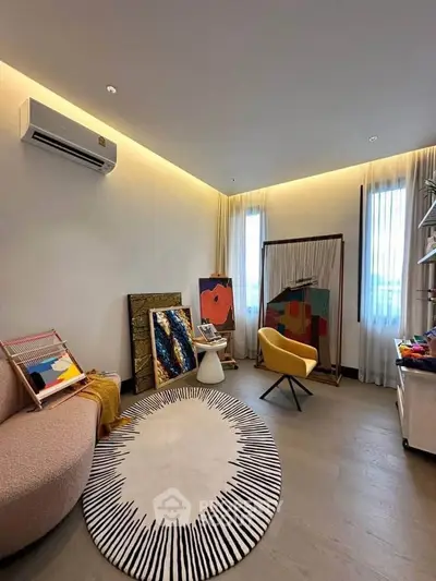 Stylish living room with modern decor, featuring unique art pieces and cozy seating arrangement.