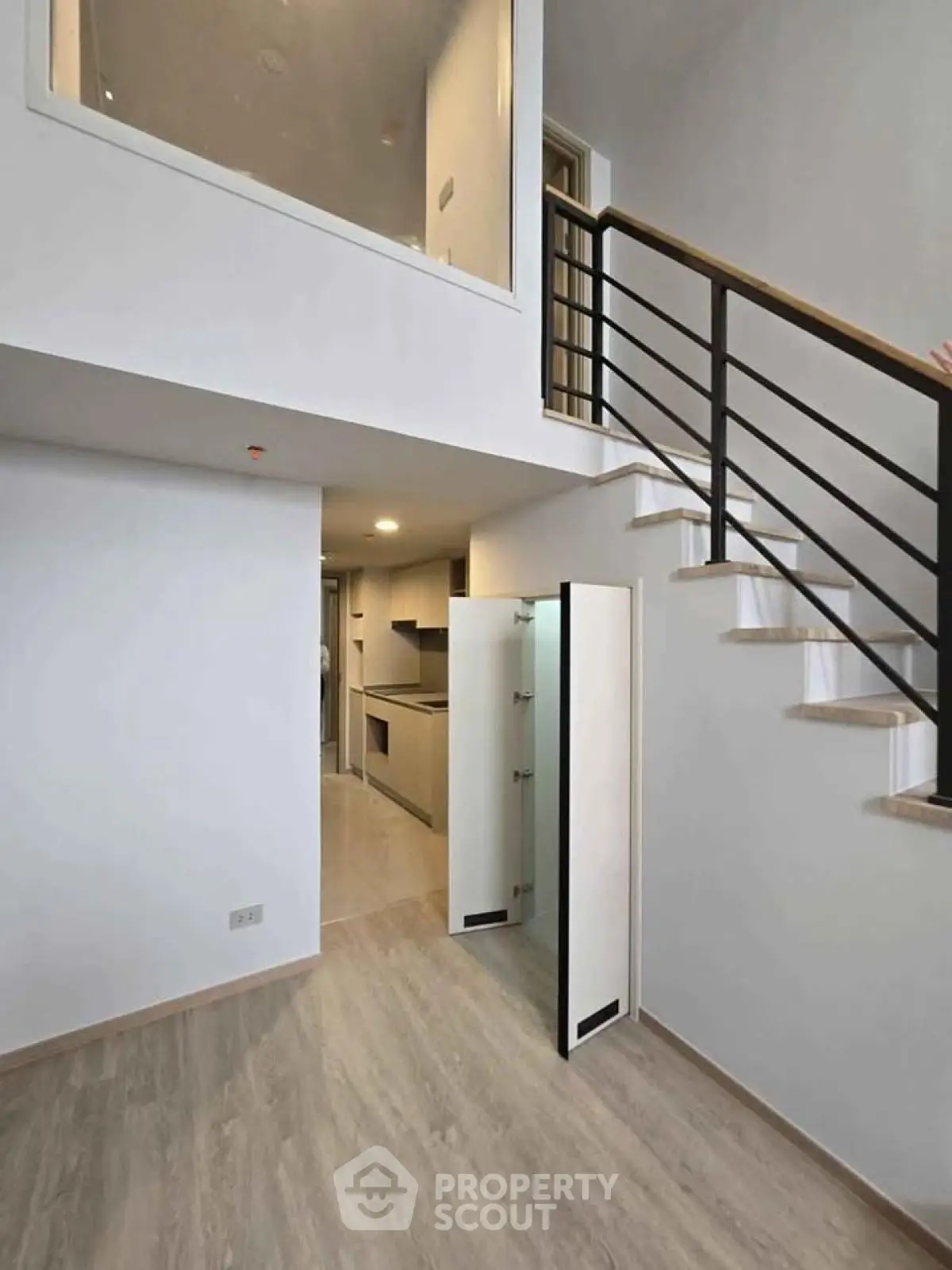 Modern duplex interior with sleek staircase and open kitchen layout
