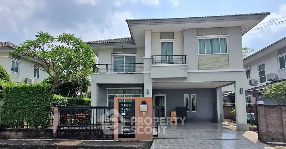 Modern two-story house with a spacious driveway and lush greenery in a suburban neighborhood.