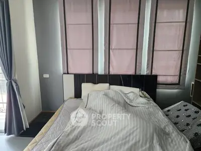 Cozy bedroom with stylish curtains and comfortable bedding, perfect for relaxation and rest.