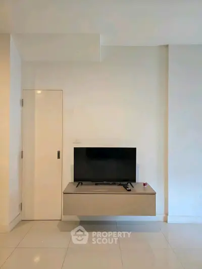 Modern minimalist living room with wall-mounted TV and sleek design