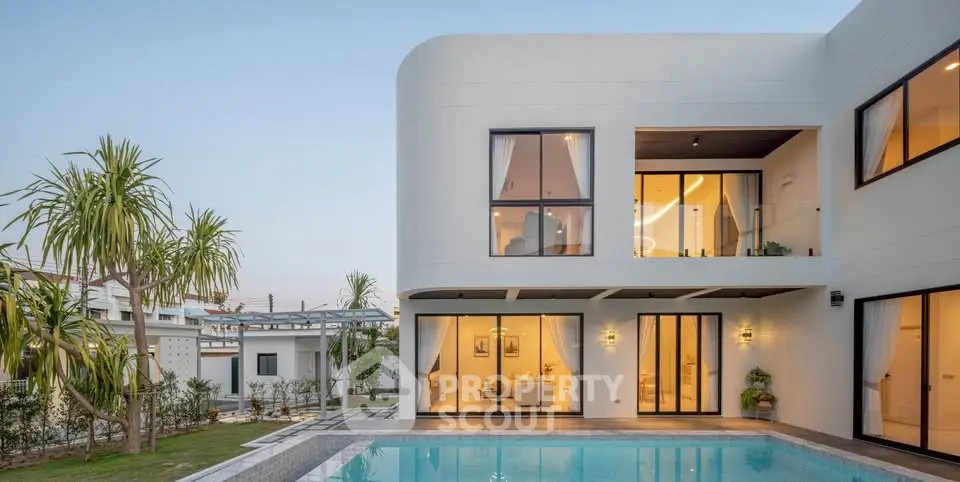 Luxurious modern villa with large windows and a pristine swimming pool, perfect for upscale living.