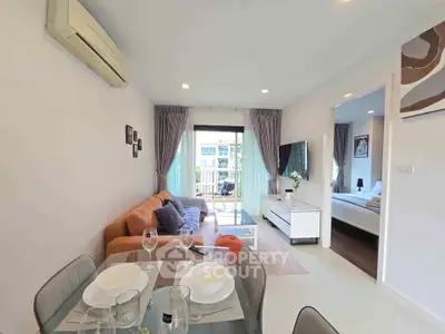 Modern living room with dining area and balcony view in stylish apartment