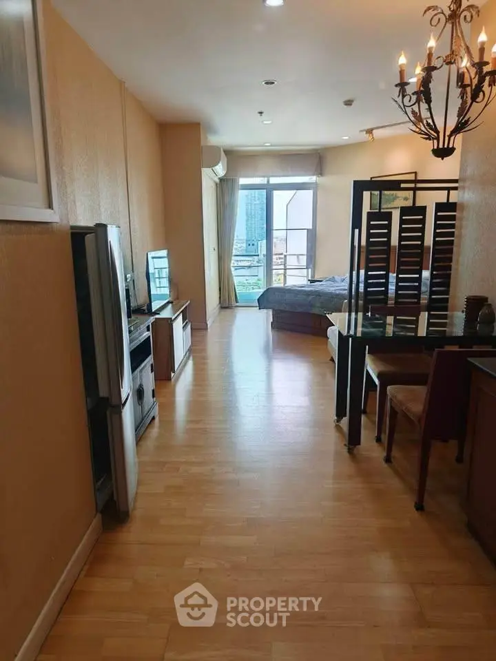 Spacious open-plan living area with modern decor and city view, perfect for urban living.