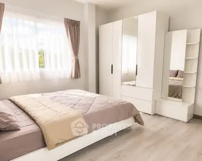 Bright and modern bedroom with stylish furniture and large window