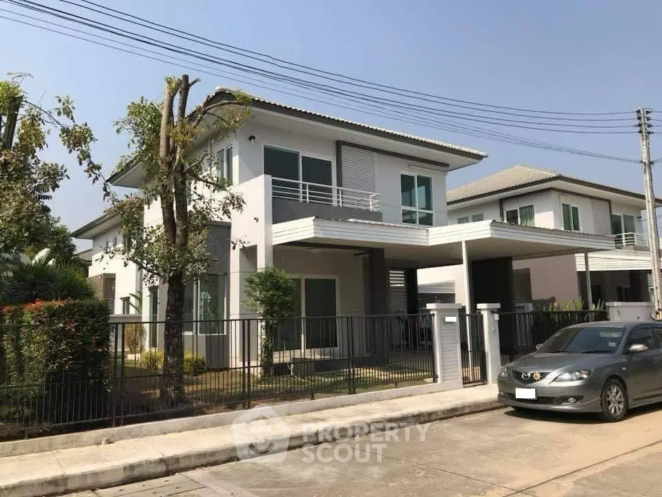 Modern two-story house with spacious driveway and lush garden