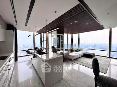 Luxurious modern living room with panoramic city views and sleek open kitchen design.