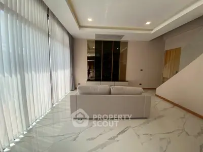 Luxurious modern living room with marble flooring and elegant sofa, featuring floor-to-ceiling windows.
