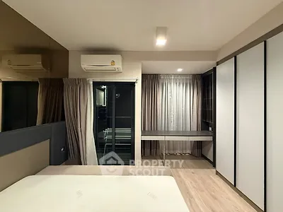 Modern bedroom with built-in wardrobe and air conditioning, featuring a sleek design and ample natural light.