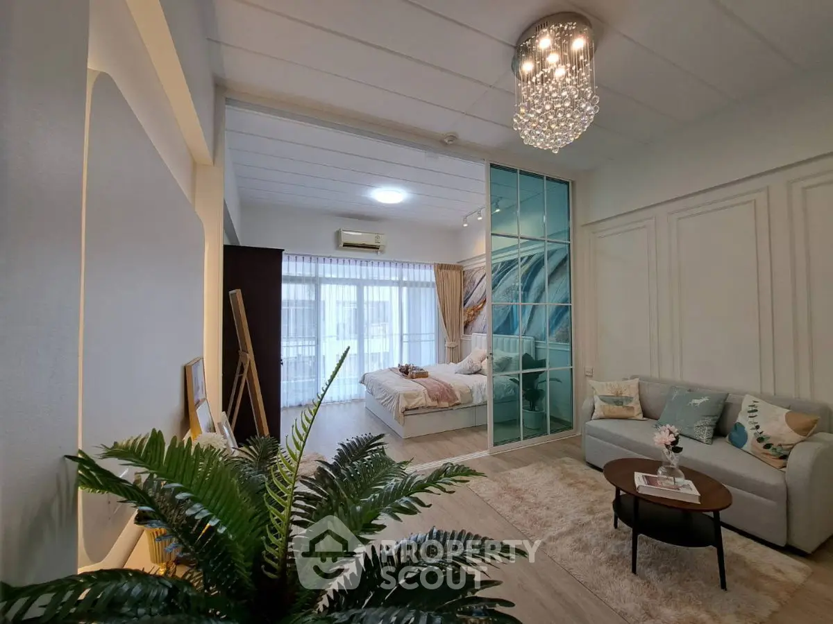 Luxurious open-plan living room with elegant decor and spacious bedroom view.