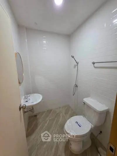 Modern bathroom with sleek white tiles and minimalist fixtures