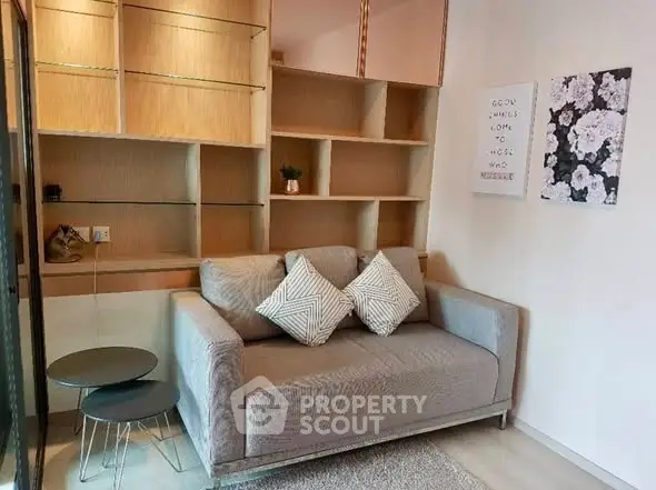 Cozy living room with modern sofa and stylish shelving, perfect for relaxation and entertainment.