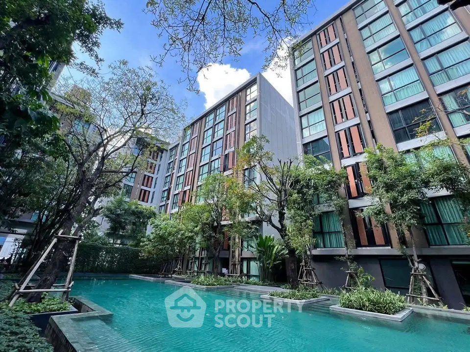 Luxurious condominium with stunning pool and lush greenery, perfect for urban living.