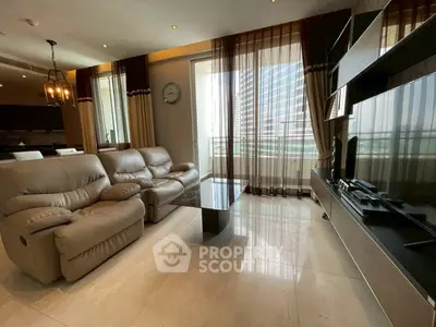 Luxurious living room with modern leather sofas and large TV, featuring floor-to-ceiling windows with city view.