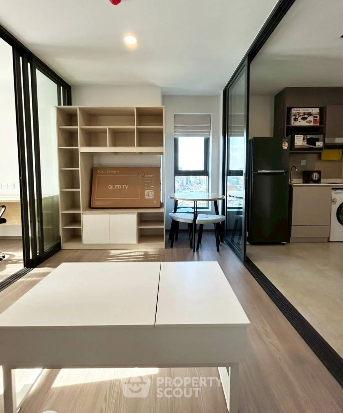 Modern living space with sleek furniture and large windows in a contemporary apartment.