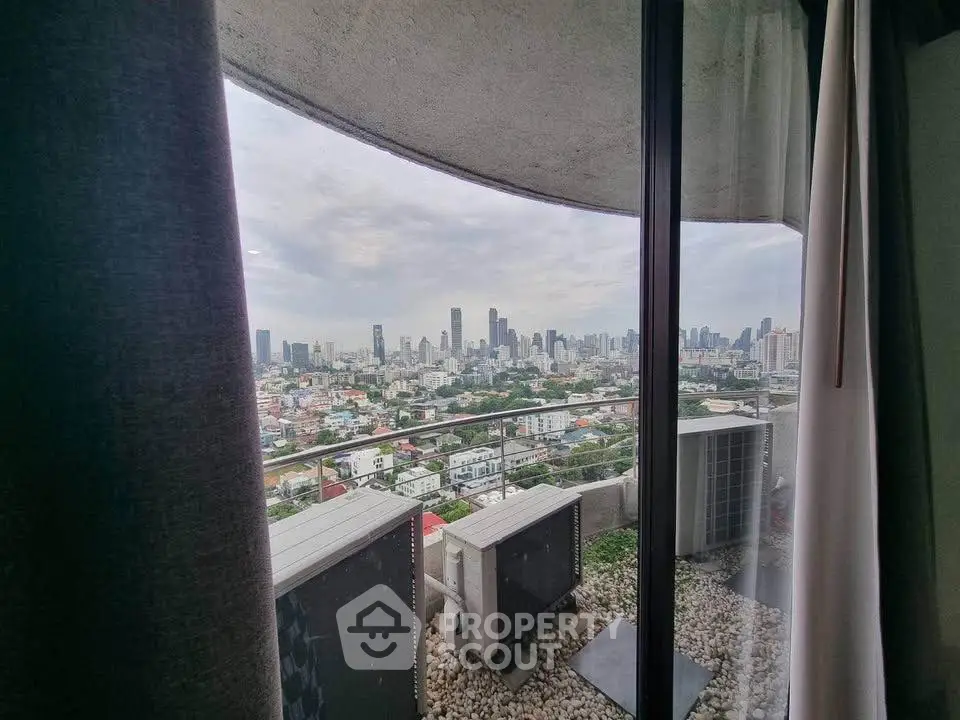 Stunning cityscape view from a high-rise balcony with modern urban skyline.