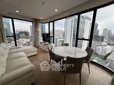 Luxurious corner unit living room with panoramic city views and elegant furnishings.