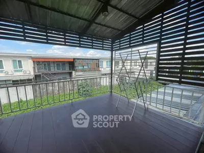 Spacious balcony with modern railing and scenic neighborhood view, perfect for relaxation and outdoor activities.