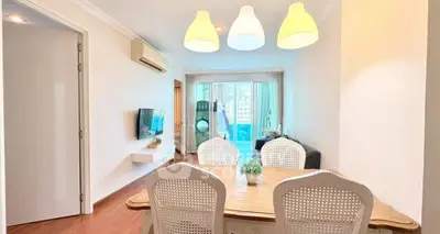 Bright and airy living room with modern dining area and large windows.