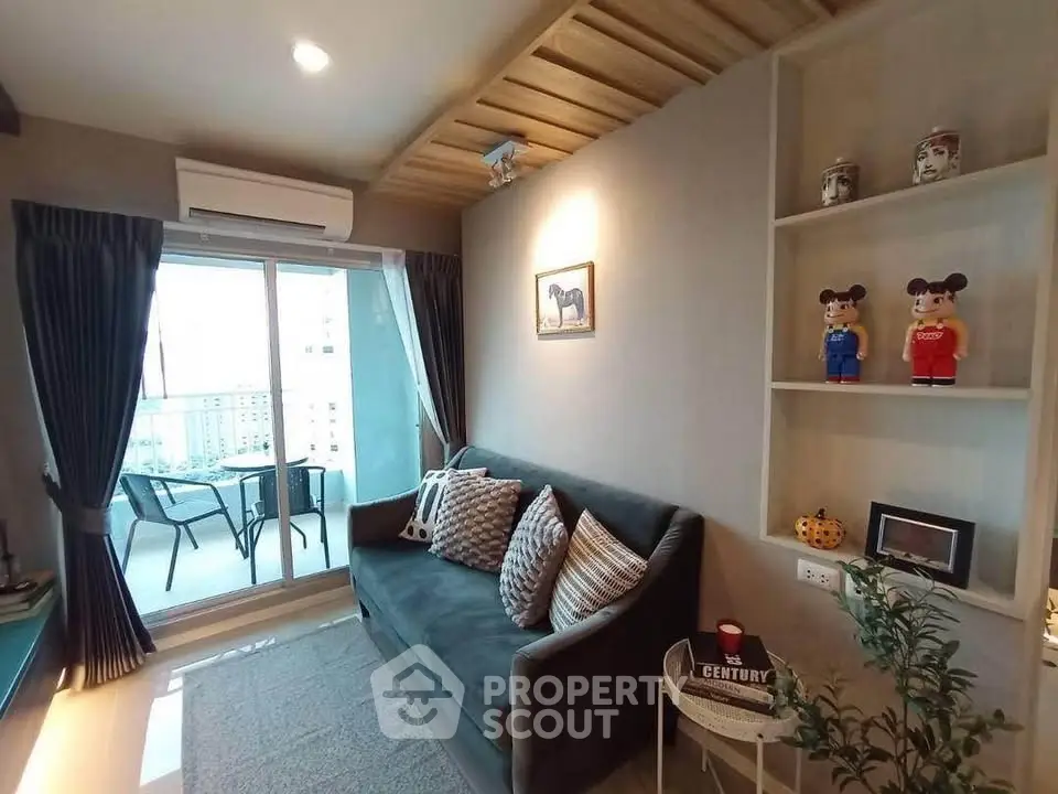 Cozy living room with balcony view, modern decor, and ample natural light.