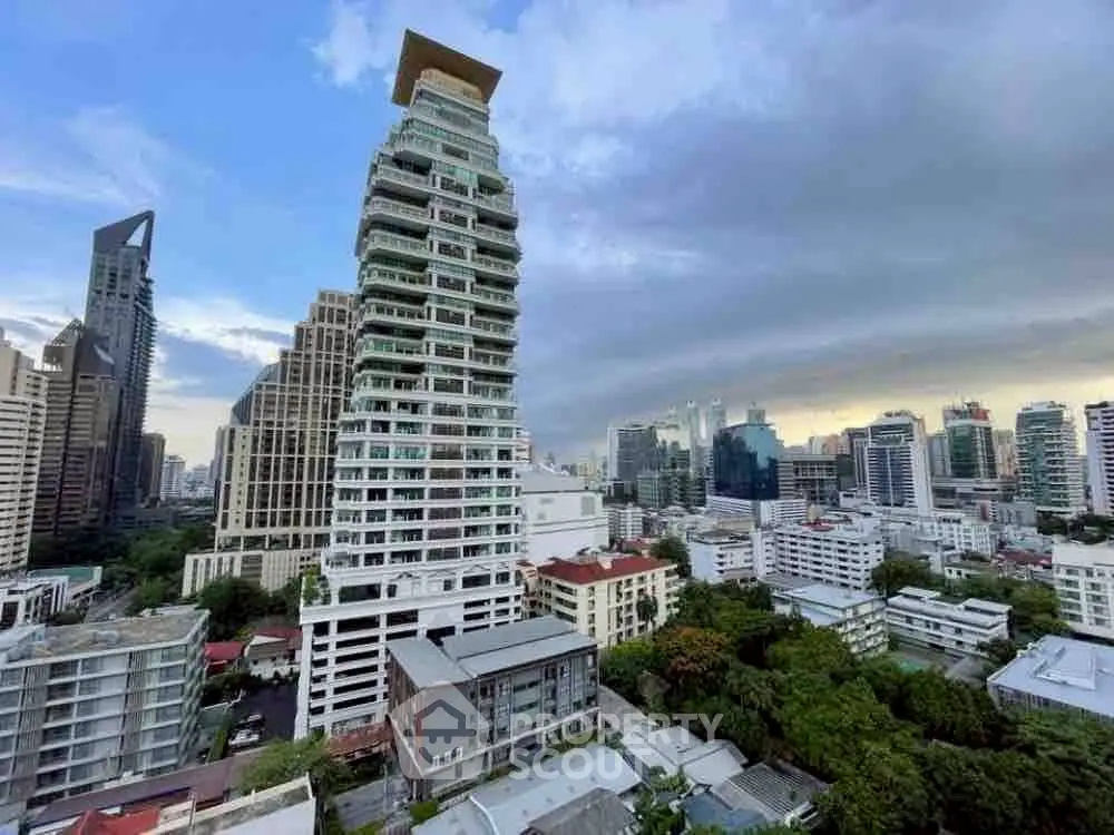 Stunning cityscape view featuring a unique high-rise building with modern architecture in an urban skyline.
