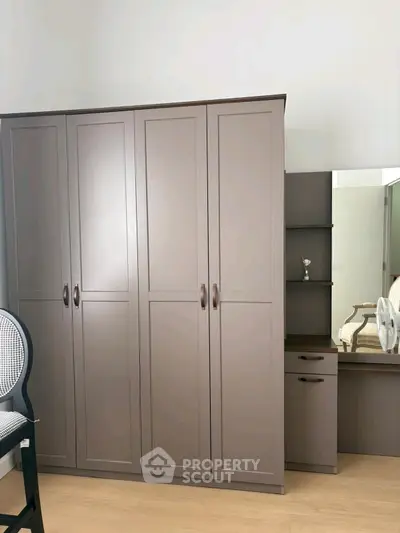 Spacious bedroom with modern wardrobe and vanity set